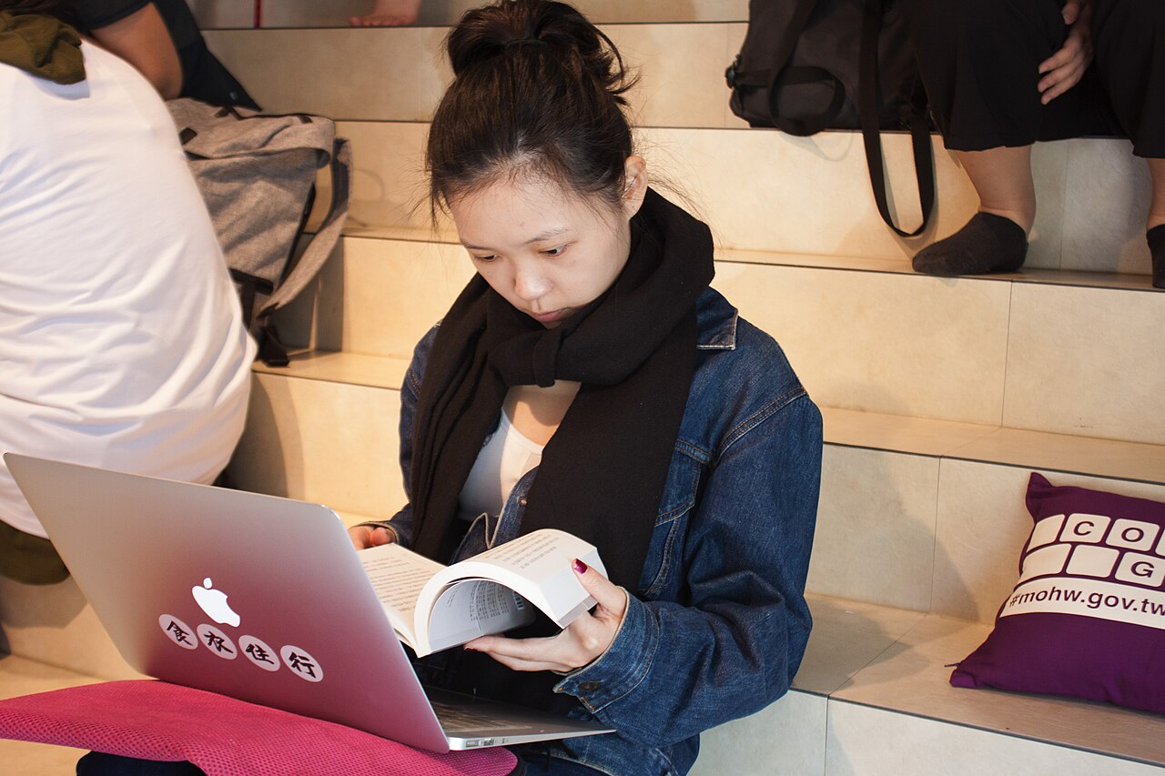 FairPlay FAQ Help Centre: question and category icons arranged around a laptop and a support headset