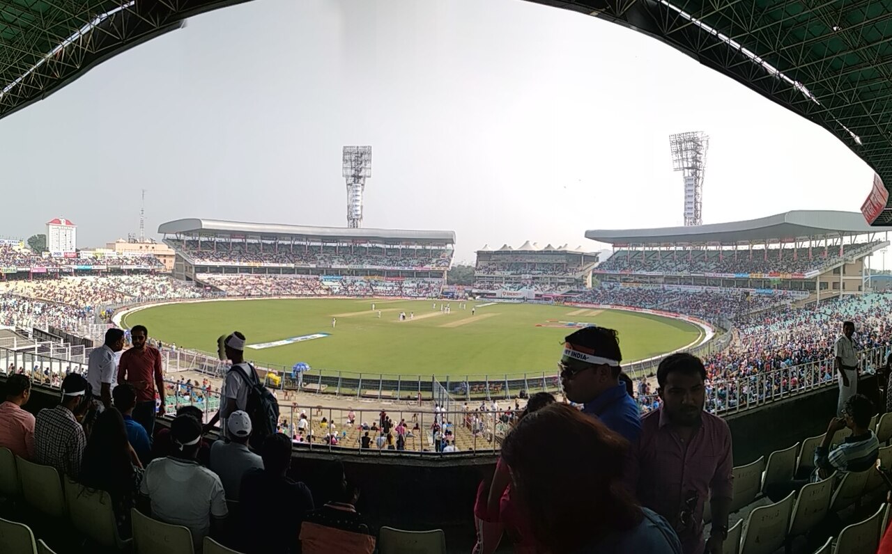 FairPlay Kolkata Cricket Stadium: a floodlit ground filling up with the Howrah Bridge on the skyline behind