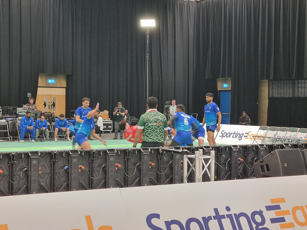FairPlay Pune Kabaddi: a raid crossing the mid-line on the mat in front of a Pune crowd