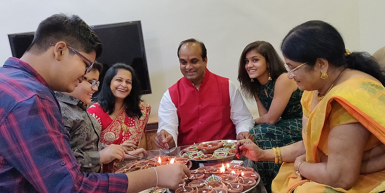 FairPlay Teen Patti During Diwali: three cards and chips among lit diyas, marigolds and fireworks