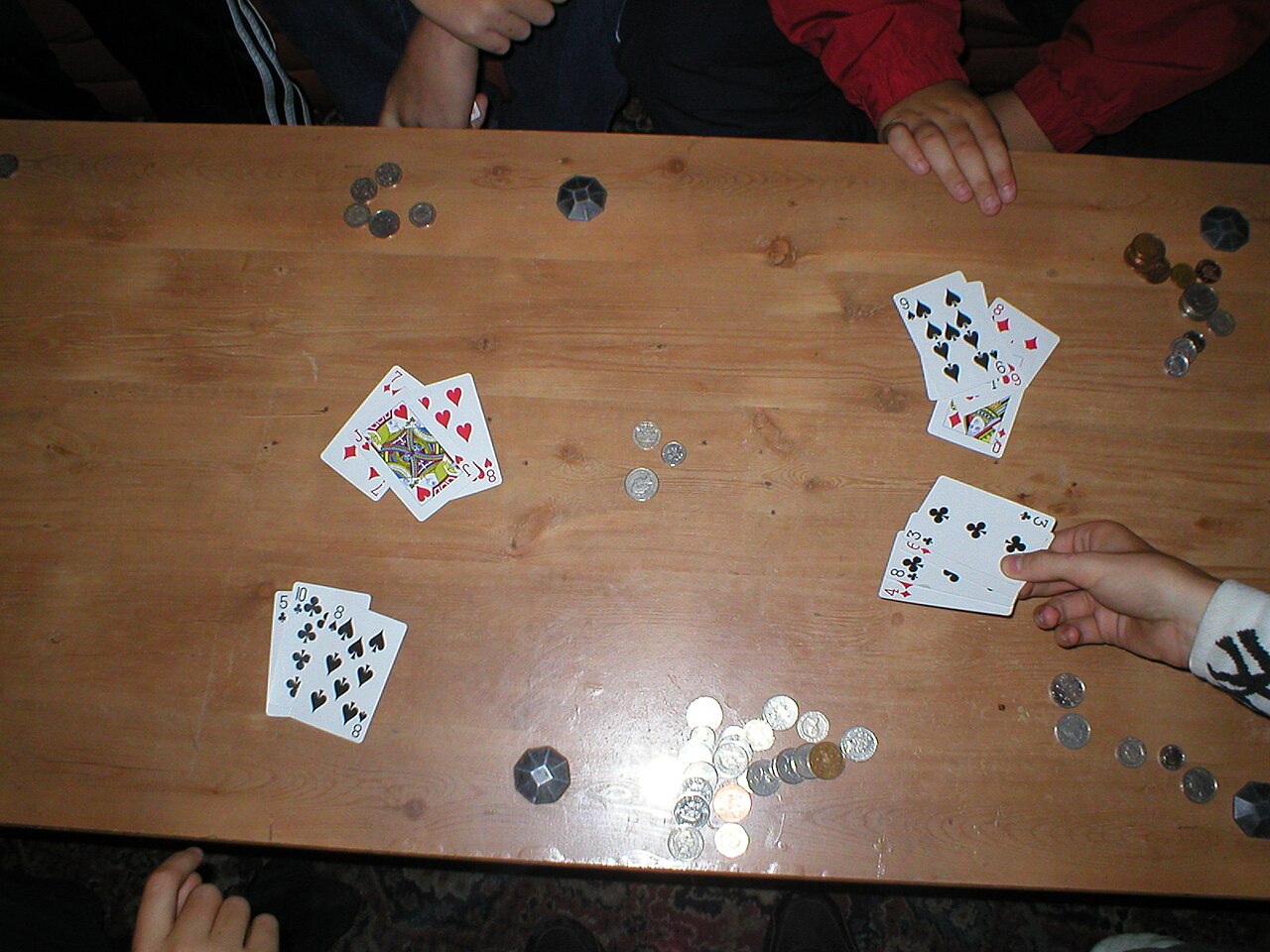FairPlay Teen Patti Table: three cards dealt face up beside stacked chips on a green baize table