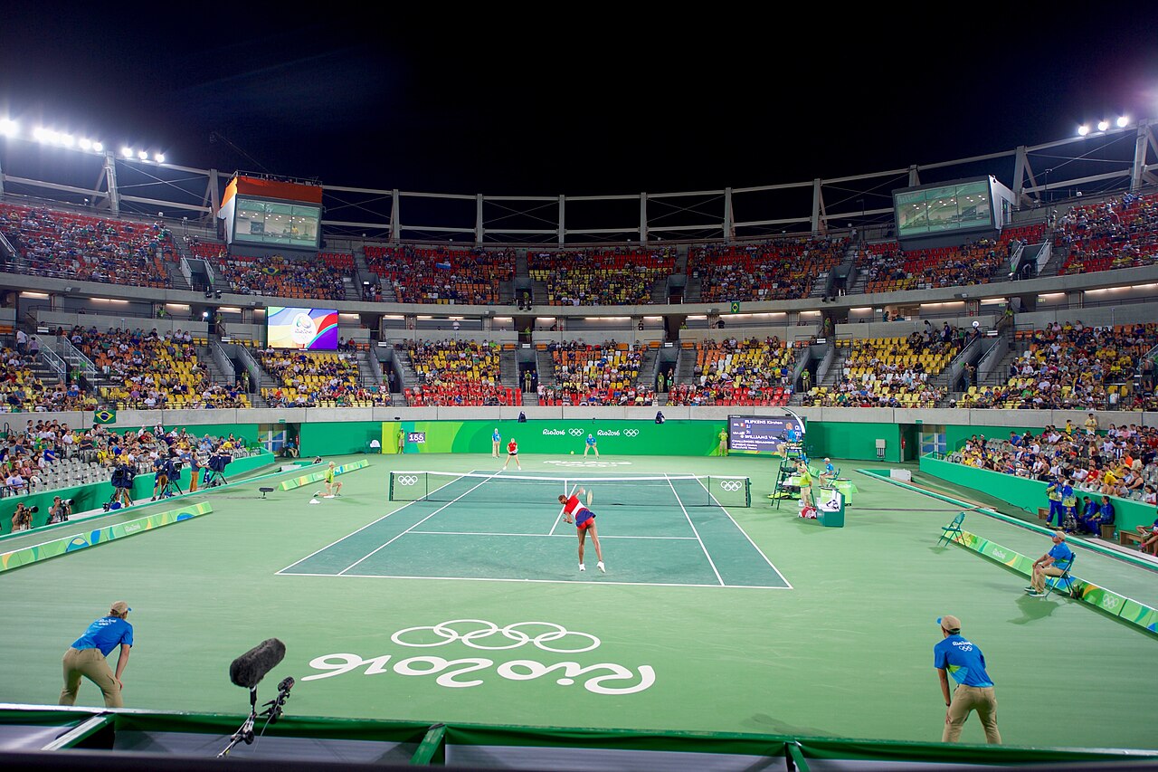 FairPlay Tennis Serve: a player at full stretch on a serve under floodlights